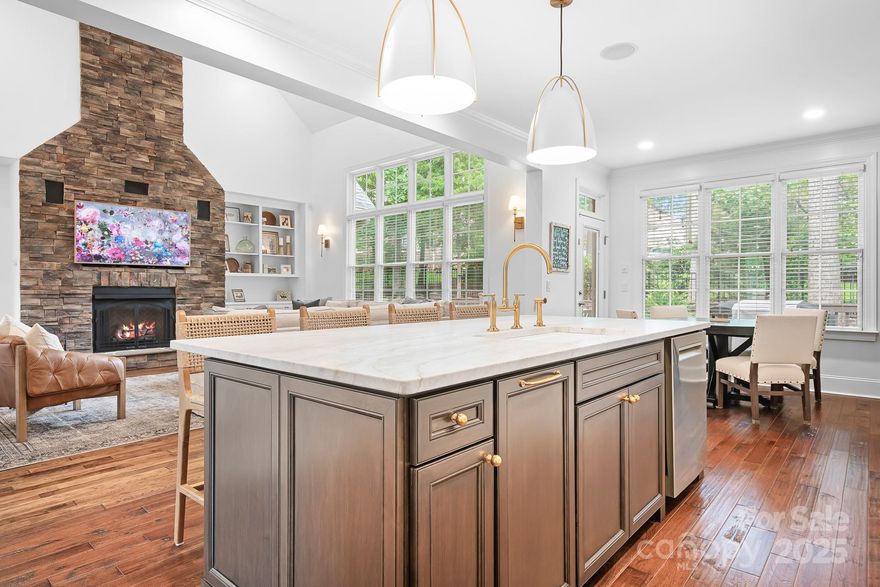 Timeless curb appeal & thoughtful updates! Adjacent to Cowans Ford Premier Golf Course & Country Club & Lake Norman! Custom, brick home enhanced by $139,000+ in recent upgrades. Kitchen remodel: Taj-Mahal quartzite, soft-close cabinetry with built-ins, premium stainless appliances, under-island storage, custom reeded glass pantry doors, & designer lighting. Wide-plank Hickory hardwoods & Mohawk carpet. Stacked stone fireplace & built-ins. Refreshed main-level owner’s suite, private office or 4th bedroom. Formal dining, breakfast room & laundry room w/ custom drop zone. Versatile loft, charming bedroom millwork & entertainment room w/ custom shelving, wet bar & beverage fridge. Enjoy extended deck, fully fenced yard, new sod & vibrant, curated landscaping. Energy-efficient: spray foam insulation, encapsulated crawlspace & tankless water heater. Immaculate!