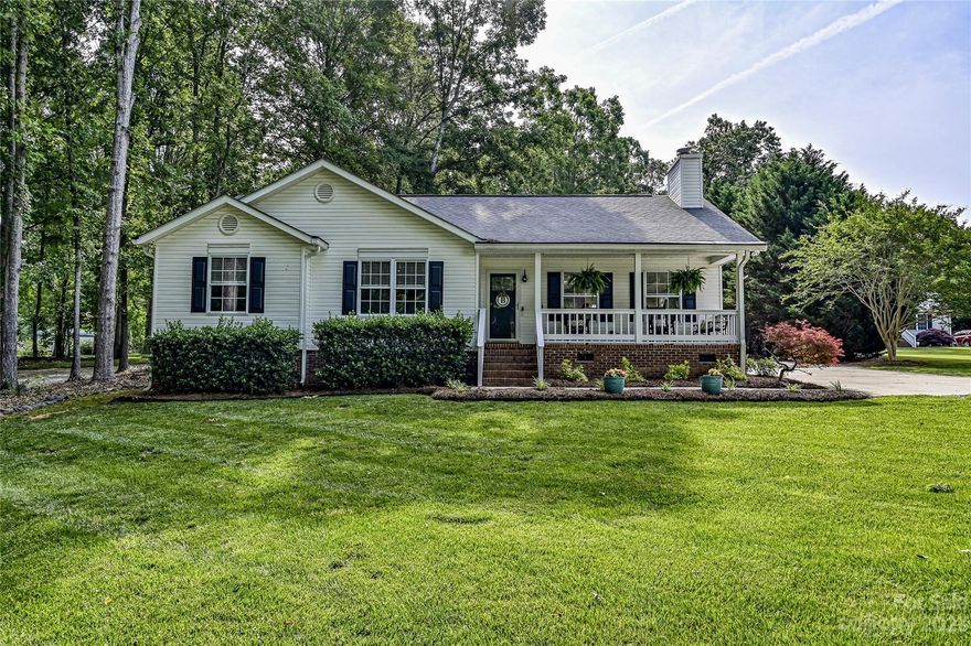 Tucked away on almost a 1 1/2 acres is where you will want to be!  A beautiful naturescape and sweet southern front porch highlights this charming ranch that will captivate your heart when you step inside.  Designed with a bright and open main living space featuring neutral tones, vaulted ceiling and gorgeous wood flooring!  Conversations and laughter can be shared through the living room with fireplace to the modern kitchen with granite counters, beautiful cabinetry and island with seating and dining area - making sure everyone is included.  Comforting relaxation in spacious bedrooms with the primary suite featuring trey ceiling.  Outside time is grand here!  The large deck will give you room to wind down after a long day, take in some warm summer rays or host that BBQ.  And from the deck - you'll see that garage with room for a workshop plus opportunities galore in the upstairs unfinished loft!  This is what country with a convenient location is all about!