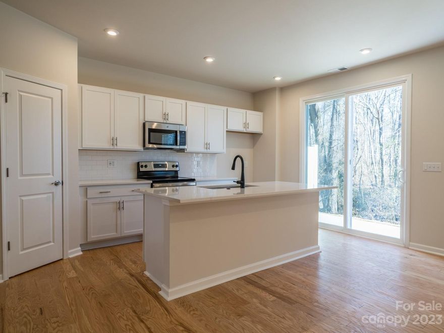Amazing Private End Unit for Sale with the Timeless II Design Package, an Upgraded Kitchen w/ 30" Electric Range, 6' Sliding Glass Door in Kitchen connecting to the Extended 6' x 12' Patio Overlooking Mature Trees, Upgraded Tile Primary Shower w/ Seat, Upgraded Secondary Bathroom w/ Tub Surround, and Added Window Coverings at a Competitive Price.

The kitchen has been upgraded with the Timeless II Design Package, presenting a high-end 30" electric range, elevated stainless steel appliances, crisp white cabinets, white subway backsplash tile, all tied together by the stylish Blanco Maple quartz counter tops. Just off the kitchen through a 6' sliding glass door is the extended 6' by 12' outdoor living space overlooking mature trees.

Upstairs, there are three bedrooms, including the primary suite, featuring an upgraded tile shower w/ seat. Adjacent to the primary suite is the upstairs laundry room and an upgraded secondary full bathroom with tub surround.