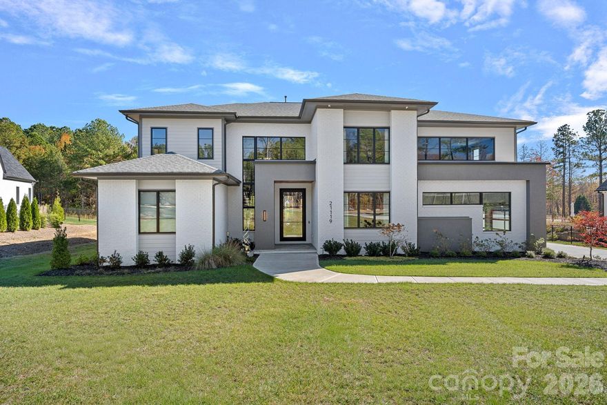 Located in Davidson Farms – Stunning Modern Home by AR Homes. This exquisite residence boasts spectacular features throughout. The primary bedroom, guest suite, and a dedicated office/den are conveniently located on the main floor, alongside a large open kitchen that includes a pass-through window to the covered porch. The great room and bar/wine room create an inviting space perfect for entertaining.Enjoy seamless indoor-outdoor living with pocketing doors leading to a covered porch equipped with remote retractable screens, a cozy fireplace, and an outdoor kitchen. A luxurious heated salt-water pool and spa add to the outdoor oasis, complemented by a 676 sq. ft. putting green featuring five cups.The kitchen is a chef's dream, featuring custom cabinetry, quartz countertops, a professional 48” range with dual ovens and six burners, plus a 48" built-in refrigerator. The spacious walk-in scullery includes a sink, dishwasher, and an additional refrigerator for ample storage.Retreat to the primary bath, which offers an oversized wet room, quartz counters, and a freestanding tub. The large, bright foyer with a floating staircase invites you into the home.Upstairs, you'll find a bonus room, club room with a wet bar, and a media room, along with three additional bedrooms, three full baths, and a half bath. There's also flex space ideal for an exercise area or playroom or walk-in conditioned storage space. Additional features include a upgraded/luxury lighting throughout, sealed crawlspace and a three-car side-load garage, making this home both practical and luxurious. Feature sheet in attachments.