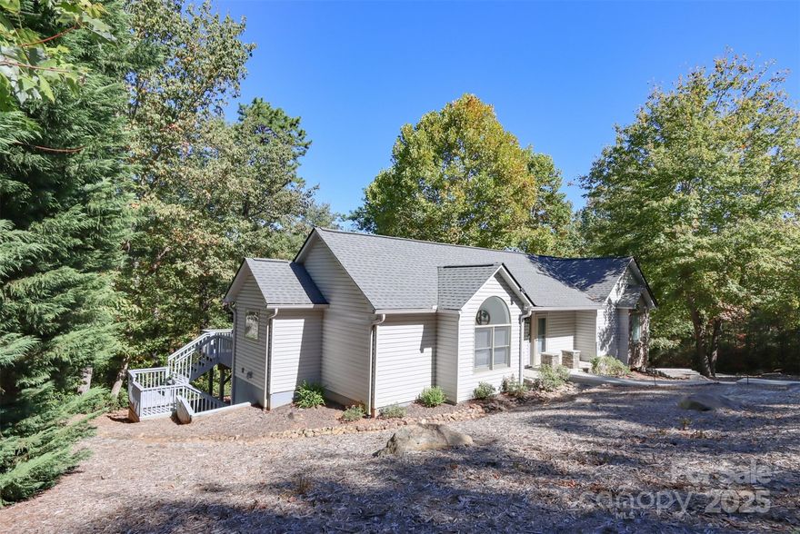 Nestled in the desirable Shumont Estates of Rumbling Bald on Lake Lure, this beautifully updated home combines mountain charm with modern comfort. With its vaulted wood ceilings, open-concept design, and expansive decks, it offers both a welcoming retreat and an entertainer’s dream.

The main level features a spacious primary bedroom en suite, generous living and dining areas, and seamless access to outdoor living spaces where you can enjoy seasonal mountain views. Thoughtful updates ensure peace of mind: luxury vinyl flooring and carpet, and a septic system upgraded in 2022 to a three-bedroom system.

The finished lower level adds versatile living space, including a bedroom, full bath, family room, walk-in closet, and wet bar—perfect for guests, a media area, or private quarters. Multiple decks and gathering areas provide an ideal setting for quiet mornings, lively barbecues, or evenings under the stars. 
As part of Rumbling Bald, homeowners enjoy resort-style amenities including private lake access, marina, indoor and outdoor pools, a wellness center, spa, tennis and pickleball courts, restaurants, and two championship golf courses. The community is a highly desired vacation destination, making this property an excellent option for a permanent residence, second home, or potential rental investment.

Beyond the gates, explore the best of Western North Carolina. Just a short drive away are Chimney Rock Village, Asheville, and the Tryon International Equestrian Center, along with endless opportunities for hiking, boating, dining, and cultural experiences.

Blending updates, location, and lifestyle, this home in Shumont Estates offers timeless appeal and a true connection to the beauty of Lake Lure. One-time initiation fee of $11,000. due at closing