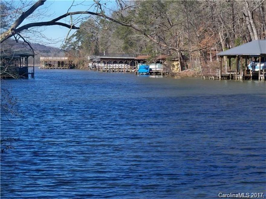 Beautiful Waterfront lot awaits the perfect buyer to build their new home. Located in a wide cove with a view of a wooded natural area. Original owner was going to build a 1800 sq ft Southland log home. The basement (42 x48) is already in place  with a septic system. Gated community so you must be accompanied by an agent. Don't miss opportunity. You can build you own private pier and boathouse. Foundation has been approved by an engineer. This is a rare find for waterfront property!!