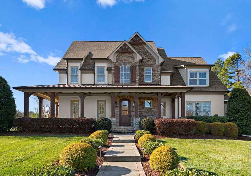 Meticulously maintained custom home in highly sought after the Woodlands of Davidson. This home has it all. Relax on the rocking chair front porch overlooking the neighborhood orchard and butterfly meadow. Then step inside the chef's kitchen with quartz countertops, gas burners, double oven, and oversized island. Entertain in the dining room with dry bar, the great room with fireplace, or the four seasons room with fans and heaters ensuring a perfect temperature all year round. After a long day of work in the main floor office, retreat to the primary suite with oversized tub, rainhead shower, and separate his/her closets. Upstairs is a large bonus with half bath, two  bedrooms with a Jack and Jill full bath, and a third ensuite bedroom. A second living area off the kitchen stairs is perfect for guests and includes a bed/exercise room plus a flex space with wet bar. Outside, the pool with hot tub, waterfall, and travertine deck should not be missed. Run, don't walk, to see this home.