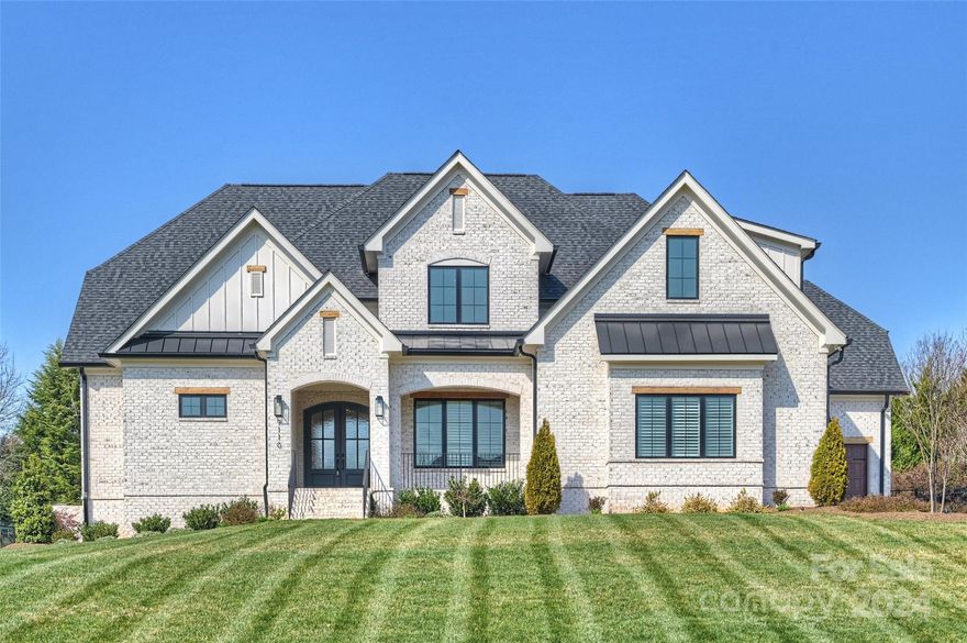 This all-brick by Linnane Homes features a modern farmhouse in the prestigious gated Providence Downs community. Walk through the crystal-lead glass doors to the stunning view of this open floor plan. Grand great room with shiplap walled gas fireplace, vaulted ceilings, french door slider leading to the spacious covered patio with gas fireplace overlooking a beautifully fenced backyard. This stunning kitchen offers a Wolf gas cooktop, kettle faucet, Bosch double oven, under cabinet lighting, a porcelain sink, and scullery w/a beverage cooler. The capacious primary ensuite has trey ceilings, a double vanity, a dressing table, an oversized shower, & a custom WIC. The primary suite & ensuite guest bedroom are located on the main level. The upper level offers 3 bedrooms, 2 full baths, a bonus room, & a home office/workout rm. This home provides hardwoods through the living & bedrms, a drop zone, a proper laundry room, & an EV outlet located in the 2-car garage. Marvin Ridge School District