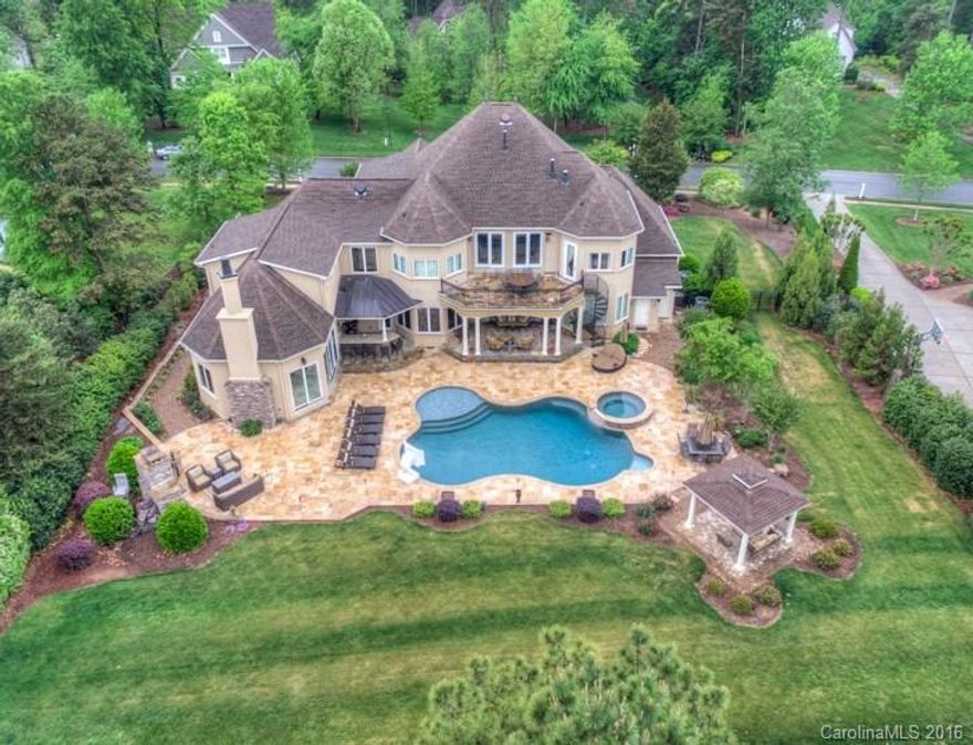 Enjoy your family, entertain guests & certainly relax w/o leaving your resort style home! A few of the incredible amenities are 2 kitchens, catering kitchen, DR, entertainment room w/fireplace & pool table area leading to amazing outdoor living, home theater, 2 offices, gym. Outdoors: summer kitchen w/bar, grill, smoker, ice maker & frig under the veranda leading to gorgeous salt water pool w/sun deck & 10-person spa. Fenced yard w/FP, gazebo & plenty of room to play. 4-car garage. Boatslip M22