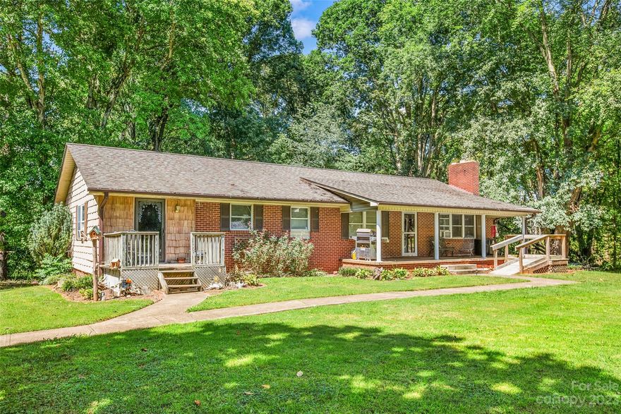 Brick ranch + unfinished basement, featuring 3 beds/2.5 baths & situated on 6.87 acres. If you love the great outdoors, this is the home for you w/ deer stands, a 1/4 acre pond & dirt tracks for your bikes already in place! Imagine days spent outside exploring your land! The covered front porch makes the ideal spot for your morning coffee. Continuing inside, you'll find your spacious living complete w/ a large fireplace. The dining room is open to the kitchen, offering you sight lines throughout & making hosting easy! Both bathrooms in the home have been remodeled & the primary bedroom has new flooring. The rest of the home features beautiful hardwood flooring or carpet & unfinished basement is 1/2 storage, 1/2 garage. Located under 1 mile from Yadkin Country Club & 4 miles to Yadkinville the location & privacy can't be beat. Get your offers in while this outdoor lovers paradise is still available!