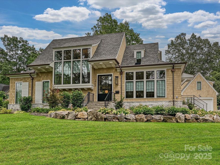Stunning like-new Grande Custom Builders home on a .51-acre lot in sought-after Old Foxcroft. With 4,568 heated SF and a detached garage with finished upper-level living space, this home blends luxury and function. A steel pivot door opens to sunlit interiors with floor-to-ceiling windows and seamless indoor/outdoor living. Custom sliding panels open to a covered porch with Isokern fireplace, skylights, automated screens, and Infratech heaters overlooking the pool and spa. The chef’s kitchen features white oak inset cabinetry, marble waterfall island, full-height marble backsplash, soapstone counters, 48" Wolf range, and 24" Sub-Zero column fridge/freezer. The scullery offers a 2nd dishwasher, Sub-Zero wine cooler, and Brizo instant hot faucet. Mudroom w/drop zone and private home office add convenience. Main-level primary suite, three ensuite bedrooms, and bonus room upstairs.  A rare offering of timeless design and modern luxury in one of Charlotte’s most prestigious neighborhoods.