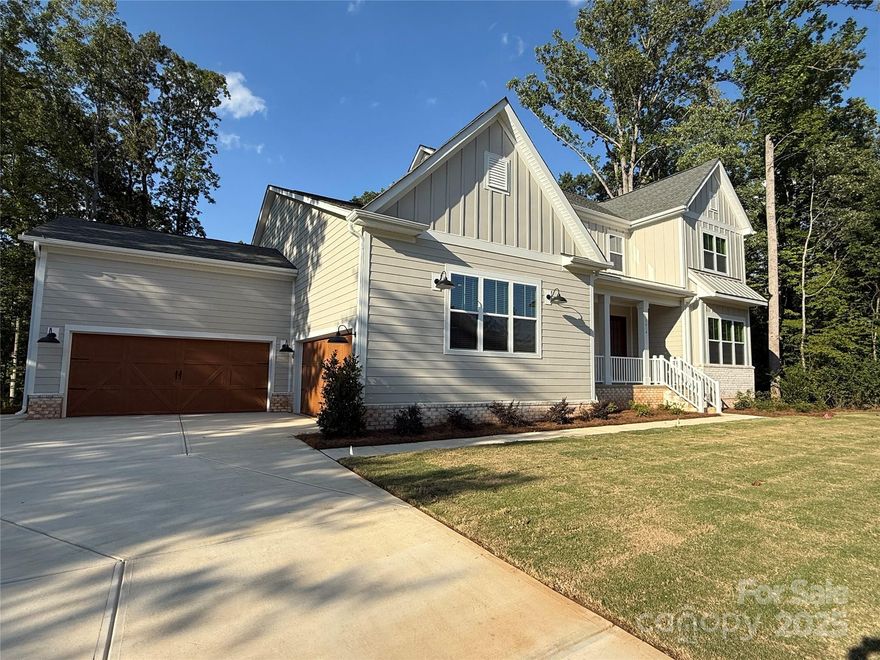 The Hampton - Modern Farmhouse Luxury Home at Bretagne in Fort Mill!  Great location, low taxes, with convenience to schools, shopping, and restaurants - close to Ballantyne and just 30 mins to Uptown Charlotte! This home offers 6300+SF and unsurpassed amenities! Spacious main level primary suite & luxe bath with designer tile, freestanding tub, large shower, double vanity, water closet & a huge walk-in closet!  Gourmet KT with 48" double oven gas range, quartz counters, oversized island, walk-in pantry; great rm with fireplace & panoramic 12' sliding glass doors lead to covered deck; guest suite on main level too!  Upstairs, find 3 add'l bedrooms, 2 baths, plus bonus room & flex space perfect for fitness, crafts, or playroom.  The finished basement adds a bedroom, full bath, media room and rec room!  Designer features thru-out along with LVP flooring & 10' ceilings w/8' doors on main level, craftsman style moldings, quartz counters in baths, upgraded lighting, plus much more!