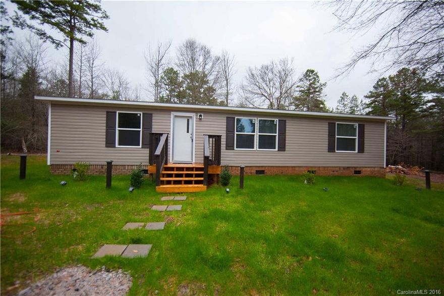 This incredible NEW home sits on 2 private ac. 7 min from I77 & shopping. Has brick underpinning, new deck, large porches & patio. Owner has replaced original inside paneling w/dry wall & replaced all windows w/Low Energy star double hung dual pane windows! Upgrades include stone back splash in kitchen & baths with ORB fixtures, rain shower faucet in tub, laminate flooring and carpet as well as all new appliances including refrigerator. Huge kit w/island and B/S. Master features huge WI closet.