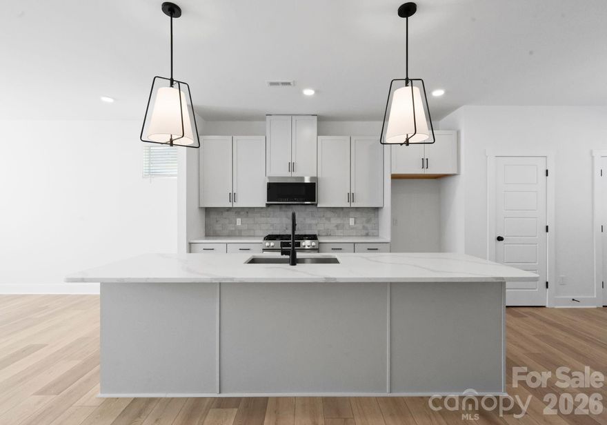 NEW CONSTRUCTION MOVE IN READY! Discover upscale living in this modern three-story townhome with over $40,000 in upgrades in City Park! Featuring a full bedroom/bathroom on the main floor, as well as, three bedrooms and two full baths on the third floor with a half bath on the second. The open-concept second floor showcases a chef-inspired kitchen with stainless steel appliances, quartz countertops, tile backsplash and designer lighting. The primary suite offers plush carpeting, a walk-in closet, and a double vanity en-suite showcasing a floor to ceiling tiled shower. Enjoy a generous rear deck, perfect for entertaining, and the convenience of a private two-car garage. These townhomes are semi-custom, a rare chance to choose from multiple design packages and finishes and make these homes uniquely yours!