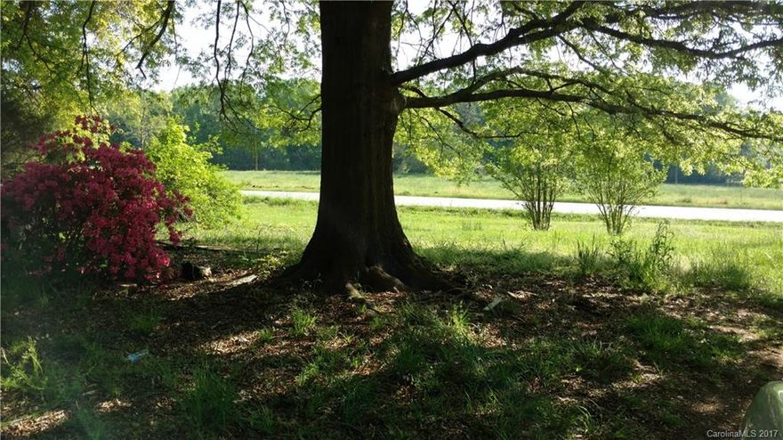 2+ acre without an HOA in Huntersville. Level home site with large garden/pasture area. Sewer line is next door. Nice country setting in Huntersville area but not in the city limits. There is an old 1970's mobile home on the property and an old open stall barn to be sold "as is". Seller makes no representations and will make no repairs.