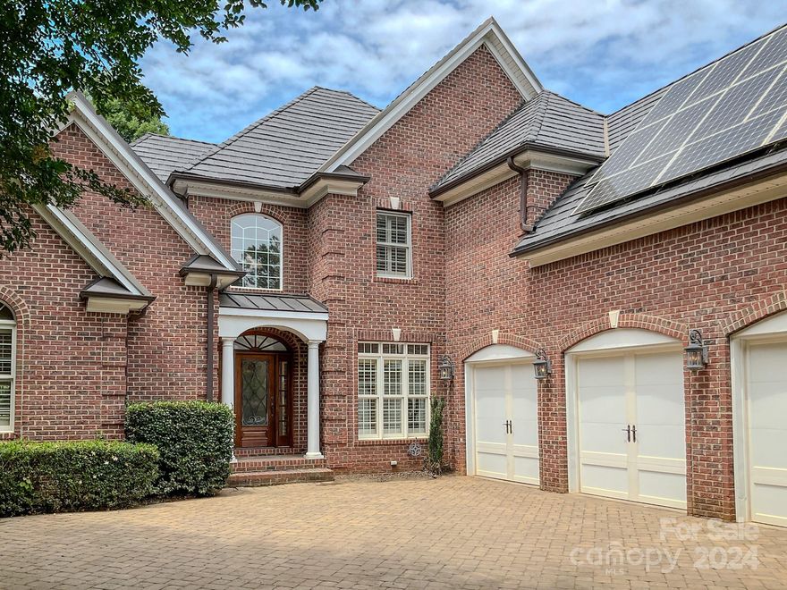 This beautiful all brick home can be found in the gated community of Hammett Cr. As you pull into the brick paver driveway, you will notice a unique roof. This roof is an imitation slate roof that is estimated to last 100 years. You may also notice the solar panels (that are completely paid for) saving you, the buyer, money, right from the start. On your right, is a very desirable 3 car garage and as you work your way around to the back of the home, you will encounter a Brazilian wood deck coming off the screened porch. From this deck as well as from other points in this home you can enjoy views of the neighborhood pond. The interior of the home has as many special features as the exterior. The dining room offers coffered ceilings, the primary bedroom, tray ceilings, and the den vaulted wood ceilings. The primary bedroom and bath are located on the main floor and feature his and her closets, a soaker tub, and a steamer shower.