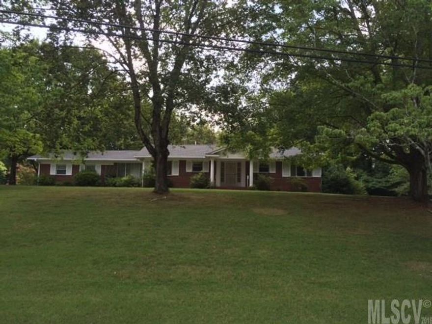 Quick Sale. Diamond in the rough! All brick home with full basement nestled on nice lot outside the city limits yet close to everything. Spacious rooms & covered back deck. Lots of potential.