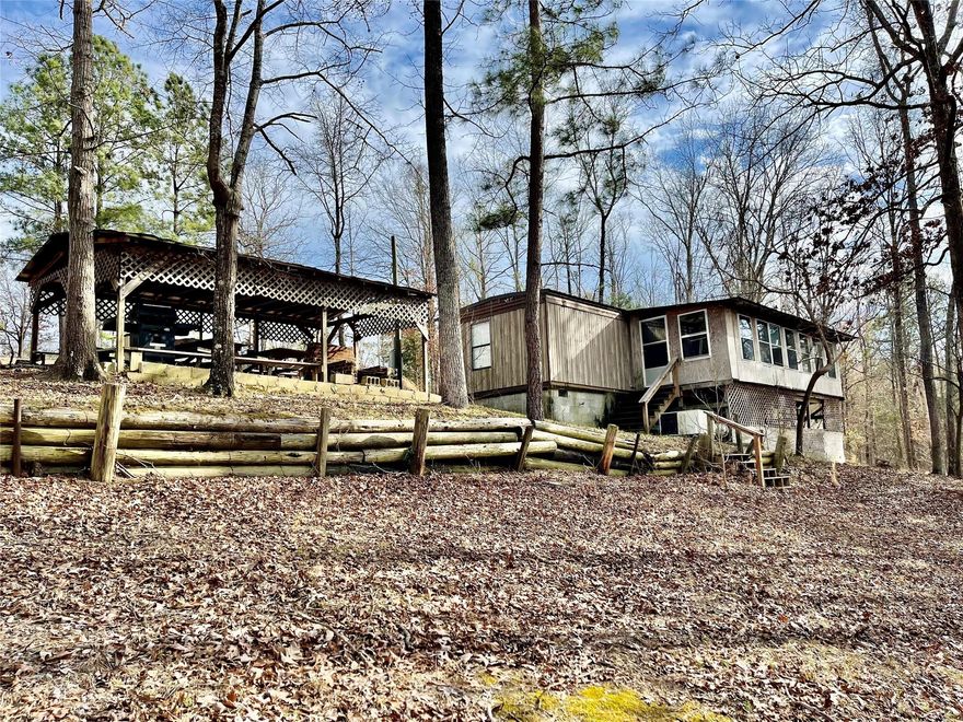 Just in time for summer! The large lot is just under an acre in size with approximately 150 feet of water frontage with paved private boat ramp and dock. The mobile home has been updated inside, had a new roof put on approximately 3 years ago and comes with all appliances including washer and dryer and most furniture. It is set up to sleep all of your guests on the built in bunkbeds. There is also a large screened porch and picnic shelter for entertaining. This weekender home is ready for summer time fun!