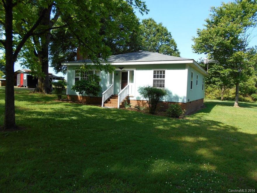 Country home W/1352 Sq. Ft. on 1.297 Acres.  Two bedroomsW/hardwood floors and one bath.  Oak framed construction, pine paneled den.  Spacious living room, large all brick fireplace.  Large kitchen & dining combination.  Energy-saving storm windows, Propane gas heat, central air.  Two Car Carport  and workshop.  Deck with ramp access.  Well pump only 2 years old.  County Water available at street.  Tap fee not paid.  Exterior painted in 2010 W/lifetime warranty paint.  Large yard W/shade trees.