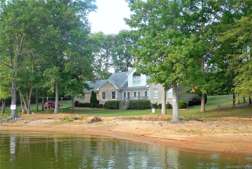 $10,000 Buyer's bonus!! WOW! 273 feet of walk in lakefront with a private pier, BEAUTIFUL VIEWS, good water, sandy beach and extremely convenient location.Only 5 min to I-85.  You've heard it said before, but this one TRULY has it all! Main level master suite,F/P in Living room, updated kitchen,breakfast nook & formal dining, Office,laundry,2nd bath. Upper level offers large den,2 bedrooms another full bath, b/i study nooks. Perfect for family or guest. Dbl attch.Gar. Did I mention the view??