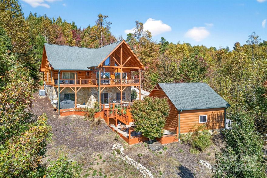 Discover timeless mountain charm in this beautifully crafted log cabin, nestled within the sought-after Grandview Peaks community. Designed for comfort and connection, the main level welcomes you with soaring ceilings, expansive windows that frame breathtaking mountain views, rich hardwood floors, and an open-concept layout ideal for entertaining. The spacious eat-in kitchen flows seamlessly into the living and dining areas, while the primary suite offers privacy and luxury with an en suite bath, walk in closet and direct access to a covered deck overlooking the Blue Ridge horizon.
Upstairs, two generously sized bedrooms, a full bath, and a loft provide additional space for guests or family, all with stunning elevated views. The finished basement expands your lifestyle options with a versatile rec room, dry bar featuring dual wine coolers, a cozy living area with gas log fireplace, full bath, and a bonus room currently used as a fourth bedroom. Step outside to enjoy the patio, hot tub pad, fire pit area, and detached two-car garage—perfect for mountain toys and gear.
Located in a gated community offering a private lake with white sandy beach, covered pavilion, games, and scenic hiking trails. Short-term rentals are currently permitted, making this an exceptional opportunity for a vacation home, income-producing property, or full-time mountain retreat.