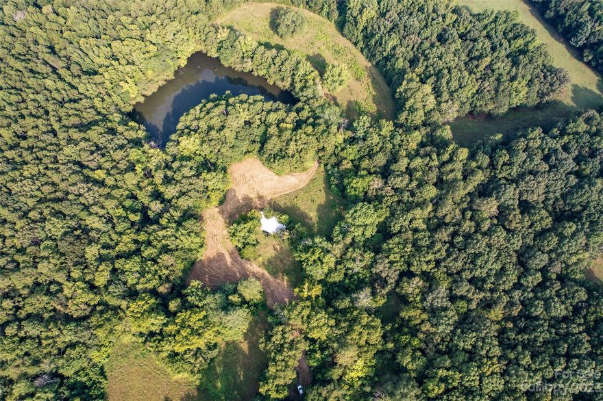 Price Reduction! 45K below appraised price! Sellers motivated so bring your offer! Beautiful 37.3 acres located in southern Cabarrus County situated in a quiet, rural setting.  No city taxes! No HOA!  3 acre lake nestled among fields and trees giving way to a number of home site possibilities.  Land borders Rocky River, so does have approximately 12 acres in flood plain.  Great location for horses, farm and animals and farming.  Old home was located on the property but burned years ago.  Cabarrus County does not have record of a septic permit.  This is the land if you are looking for a quiet, secluded paradise.