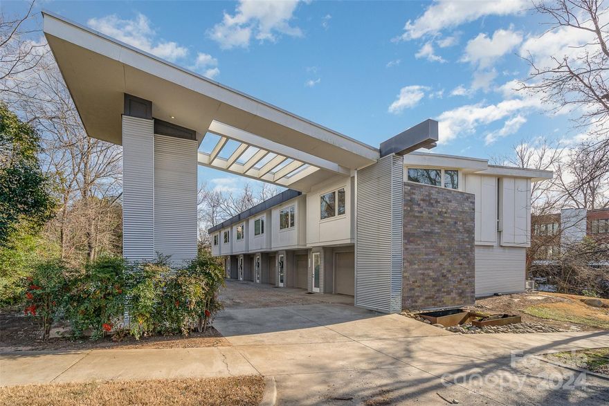 Very rare, modern townhouse in an unbeatable location steps away from everything NoDa has to offer! 
Enjoy a private, attached garage with ample storage and large bonus room on the lower level serving as an office or bonus room with a covered back porch. Ascend the steps in the entryway to your main level boasting beautiful 13' vaulted ceilings with an open floor plan, large windows letting in natural sunlight and a private balcony to enjoy the fresh air. Down the hallway is the primary bathroom and large primary bedroom with walk in closets. Truly a unique property in an unbeatable location in one of the most desirable and artistic neighborhoods of Charlotte!