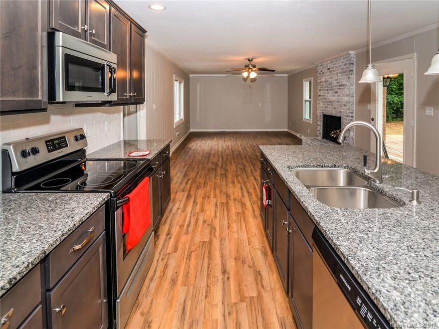 Completely remodeled home on a large wooded lot. In ground pool and gazebo. Kitchen with new cabinets, appliances.  New paint, flooring throughout.  Ceiling fans in all four bedrooms -including 2 master suites.  Entire home has been remodeled down to every small detail. Entertain in this open floor plan that walks out onto deck and beautiful back yard. Quiet street but minutes away from dining, shopping and I-77.  $2k landscaping pkg w/acceptable offer. This house won't last long!