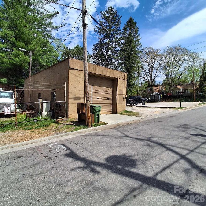 Haywood Road Corner lot with plenty of parking. This block Building/Garage has been leased to an auto shop for many years. Owner is selling out. Building has plenty of potential and is on the back corner of property with garage door facing Brownwood Ave. The front portion of Parking lot is rented monthly to a taco shop. Use address of 26 Brownwood Ave, although tax office has 0 Haywood Rd. Call listing agent to show.