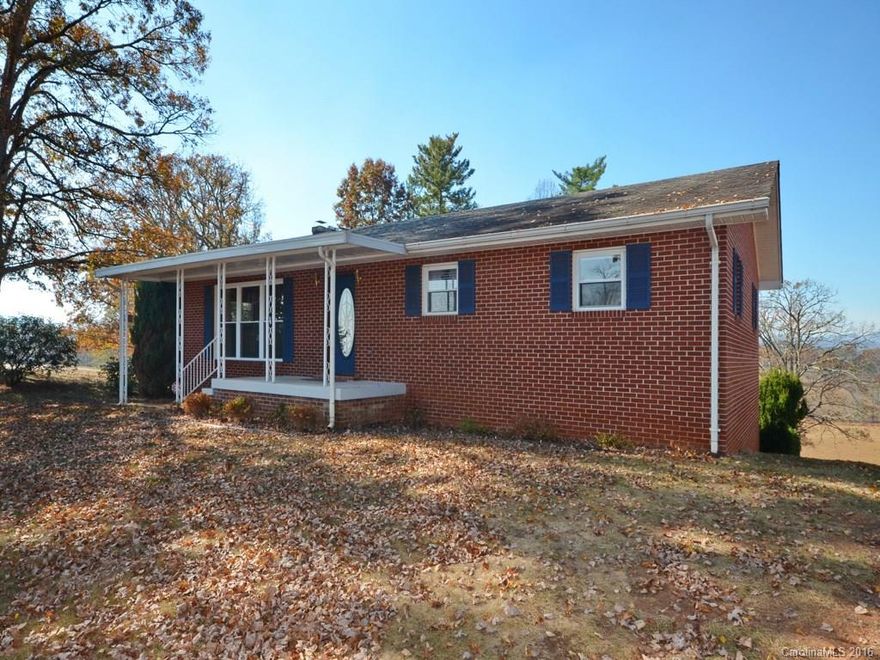 This 1965 brick ranch has good bones, beautiful real wood paneling throughout the main level, and great views!!! The Main Level has a wood stove in the dining/kitchen area, plus 3 bedrooms, 2 baths on that same floor. The previous owners finished 2 more bedrooms and a rec room in the basement with a sliding door, walk-out to back of house, creating a light & bright lower level! Best view in WNC for the $. You can see all the way to the Smokies in Haywood County!
