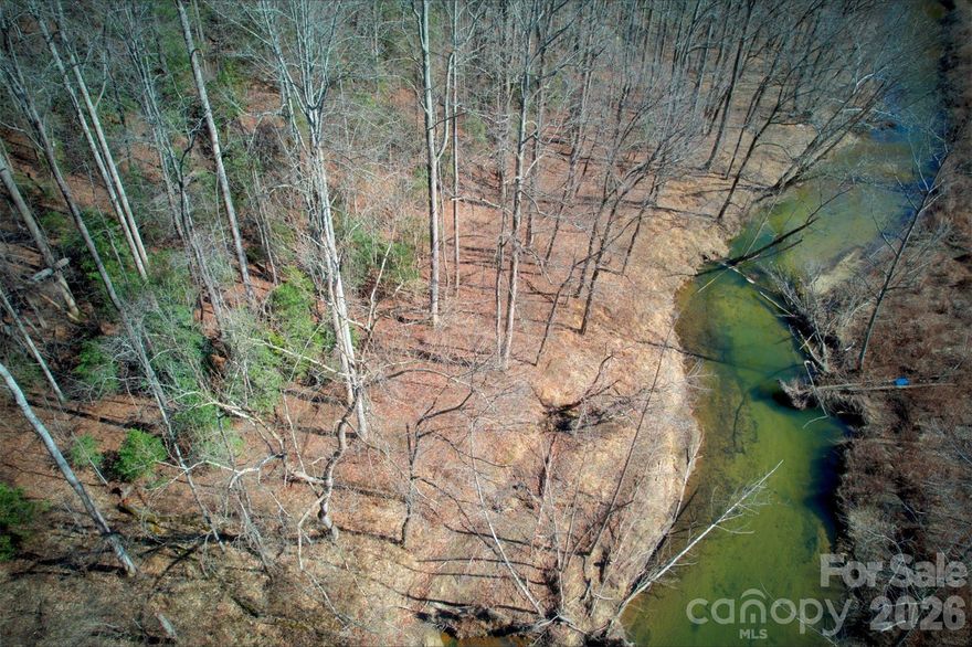 Beautiful 10-acre tract in Caldwell County, NC. Raw land with sloped terrain on riverfront. River not owned with property. Power available at lot line, well-verified aquifer for water, septic needed. Paved road access via deeded easement. Near Lenoir (8 mi), Blowing Rock (13 mi). Outside flood zone (Zone X). Ideal for homesite, mini-farm, or recreational use. RA-20 zoning allows residential-agricultural use. No HOA restrictions.