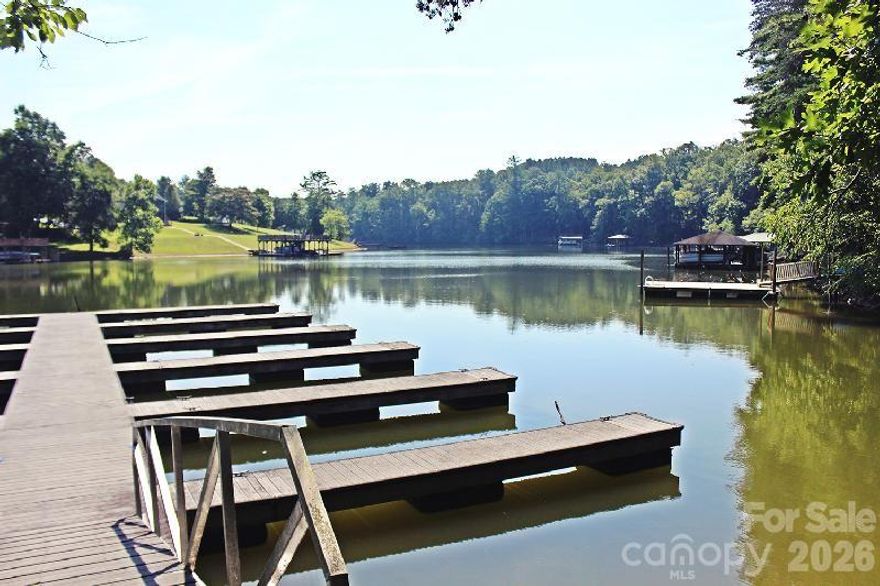 Welcome to Lake Hickory life. This 1.34-acre wooded homesite sits inside the gated, lakefront
community of Plantation Pointe — one of Granite Falls' most sought-after addresses and one of the
few remaining buildable lots in this established neighborhood. A serene creek runs along the back of
the property, and the adjacent parcel is HOA-owned — guaranteeing permanent privacy and natural
views that will never be built on. Residents enjoy a beautifully landscaped gated entrance, privately
maintained paved roads, underground utilities including fiber internet, a community boat dock with
rentable slips, and a secure fenced boat storage lot — everything you need for true Lake Hickory
living. Under an hour to Charlotte, minutes to the Blue Ridge foothills, and just steps from the water.
Septic permit in progress with a potential site plan ready — a genuine turnkey build opportunity.
County water tap available at the street; seller is paying the tap fee at closing. Cash preferred. Learn
more about the community at plantationpointe.net. Please note: NO SIGN is permitted per HOA — all
showings by appointment with a licensed agent. Do not enter the gated community or visit the lot
without your agent present.
