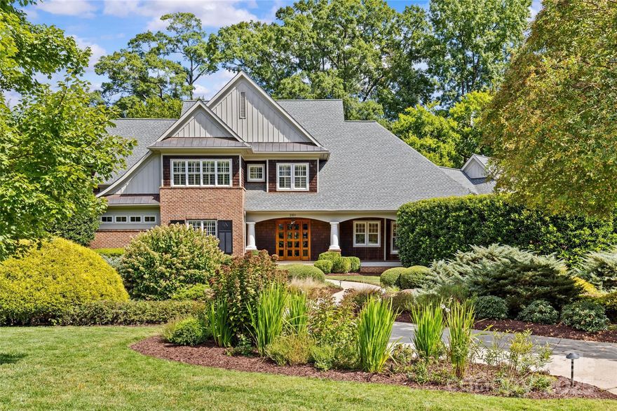 Luxury living in Charlotte! This exceptional home on .96 acres showcases a charming covered front porch and a beautifully landscaped private, flat backyard.  This floorplan, which includes a sliding glass wall, allows for effortless entertaining and everyday living.  A show-stopping chef’s kitchen with large island, top of the line appliances and walk-in pantry opens to a cozy breakfast area, spacious fireside living room, wine cellar and vaulted dining room.  Unique, custom & high-end finishes throughout.  Primary suite on main level with grand ensuite bath featuring double vanity, barrel ceiling shower with steam, soaking tub & walk-in closet.  Three additional bedrooms plus gym/fifth bedroom upstairs all with ensuite spectacularly updated baths and walk-in closets.  For added privacy, a separate staircase leads to bonus room/second living quarters with dishwasher, refrigerator/freezer drawers, microwave, full bath, and walk-in storage. Extend entertaining outdoors and enjoy fireside dining on the screened porch overlooking a private fenced backyard, outdoor patio with firepit and lush landscaping.  Front porch swing may be your most cherished space. Garage entry features a drop zone with built-ins and laundry room.  Extended driveway allows for easy and ample guest parking.  Full house generator and conditioned crawl space.  This stately home is convenient to uptown as well as premier shops & restaurants in the Myers Park, Cotswold and SouthPark areas.