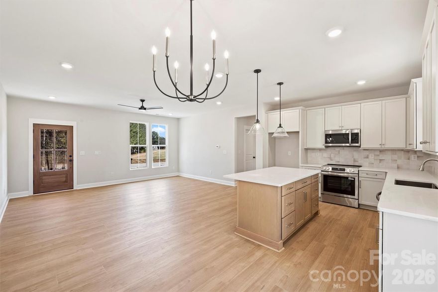 Recently completed and now available in North Pines, 2279 Lee Lawing Road offers thoughtfully crafted single-level living by Brancer Homes. This new construction home blends modern comfort, elevated finishes, and the privacy of tree-lined homesites, all just 15 minutes from downtown Lincolnton and convenient to shopping in Sherrills Ford and Denver.

Charming curb appeal begins with stone accents and a stained wood front-porch column, creating a warm and welcoming entry. Inside, the builder’s Earthy Designer Package showcases nature-inspired tones, curated lighting, upgraded cabinetry, a walk-in pantry, and quartz countertops throughout for a cohesive and refined feel.

The open-concept kitchen features pendant lighting over the island, upgraded cabinetry combinations, and seamless flow into the main living spaces—ideal for both everyday living and entertaining. The spa-inspired primary suite offers a beautifully tiled shower wall, stand-alone soaking tub, and a calming designer palette complemented by crisp white ceilings.

Additional highlights include a functional drop zone, added recessed lighting, and a well-appointed laundry room with cabinetry and quartz counters for added storage and convenience. An extended two-car garage with additional driveway parking enhances everyday functionality.

Now that construction is complete, this home is part of a newly released collection in North Pines—offering a rare opportunity to own move-in ready new construction with elevated design and natural privacy in one of Lincolnton’s fastest-growing areas.
Designed for low-maintenance living with a peaceful rural backdrop, this home combines thoughtful craftsmanship, modern design, and Carolina charm—perfectly positioned in the heart of Lincolnton. Current photos are representative of other completed homes.