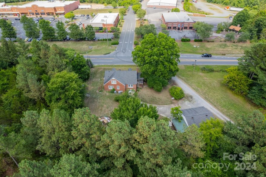 This unique property's C2-zoned location offers high visibility. It's located near the 601/49 intersection across from the Food Lion Shopping Center. The residential home's layout will allow it to be split into two work areas with a shared bathroom and kitchen. The property offers two entrances. It would be suitable for conversion to a Salon, allowing space for multi-services or renovation for other commercial uses. The detached garage provides two bays and an upstairs that can be turned into an apartment or business office/storage space. You can also demo and start fresh. This is a great business opportunity in one of Concord's rapidly growing areas. Developers, please see listing # 4201836 linked parcel