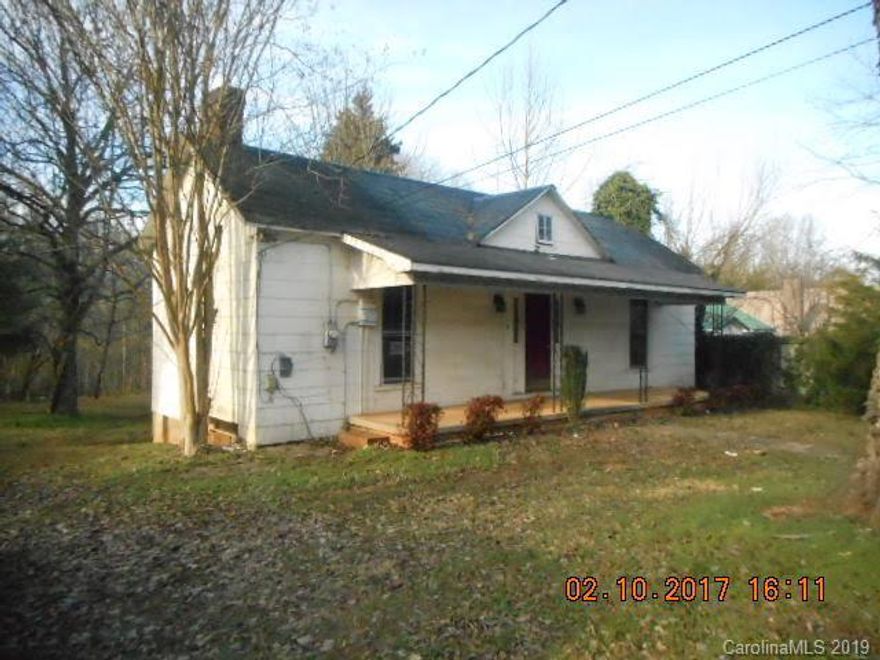 Most of the house has high ceilings except enclosed porch area, which is 217 HSF, includes bathroom and laundry, and is below 7 feet.  Great location, close to I-40, downtown, hospital, and restaurants. This 2 bedroom, 1 bath home on extra large lot has large rooms and each bedroom has 2 closets. Most windows have been replaced.  Sold AS-IS. Functionality of systems is unknown. Financing available through First National Bank of America.