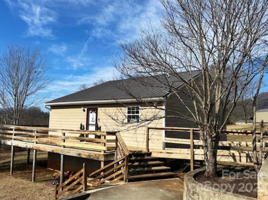 CHARMING AND MOVE-IN READY! This adorable 2bdrm/1ba is centrally located between Asheville and Waynesville perfect for any commute. Featuring an open floor plan with a spacious kitchen and large walk-in pantry. You'll love the size of the full bath! BUT, what you'll love the most is the huge yard, perfect for fido or the kids to romp around. Enjoy those summer evenings on the wrap around deck and take in those gorgeous sunsets and mountain views. Seller is relocating, so now's your chance to snap up this adorable home. Ideal for year round living with easy paved access.