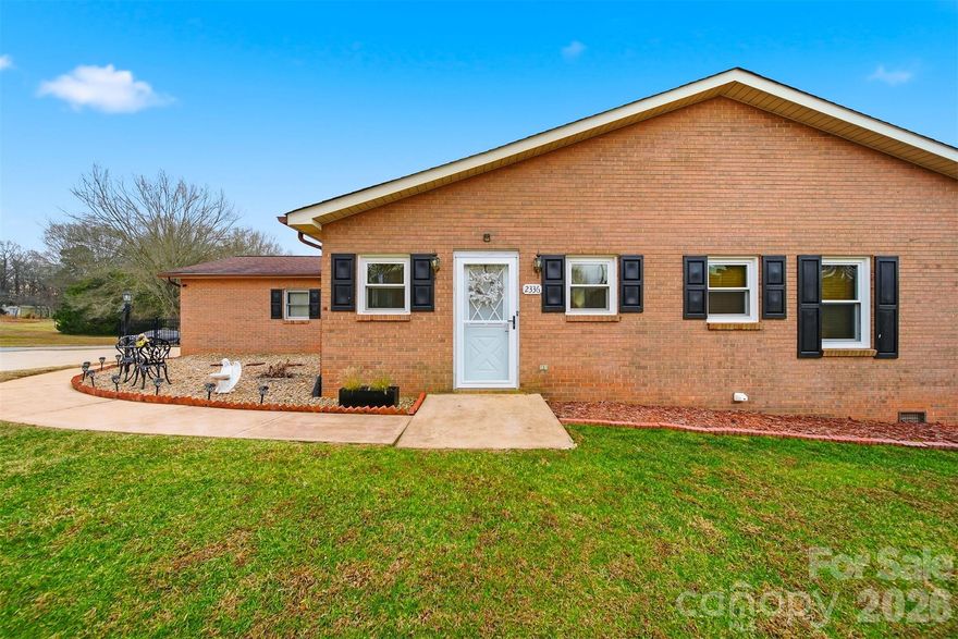 2336 21st Ave NE, Hickory, NC presents an exceptional opportunity to own a low-maintenance, all-brick ranch in one of Northeast Hickory’s most convenient residential pockets. Positioned on a spacious .39-acre corner lot, this property offers a rare combination of one-level living, functional outdoor space, and everyday accessibility to shopping, dining, and medical services—making it a highly attractive option for today’s lifestyle-driven buyers.

Inside, the home features approximately 1,600 square feet of thoughtfully connected living space. The open layout allows the living room, kitchen, and dining area to flow seamlessly together, creating an environment that feels welcoming, efficient, and easy to live in. This design supports both relaxed daily routines and casual entertaining, with natural sightlines that maximize the sense of space and connection throughout the main living areas.

With three bedrooms and two full bathrooms, the floor plan offers flexibility for a variety of needs—whether that includes dedicated work-from-home space, guest accommodations, or hobby rooms. The single-story configuration eliminates unnecessary stairs and promotes long-term livability, a feature that continues to grow in demand across the Hickory market.

Step outside and you’ll find one of this home’s most compelling advantages: a cleared, level, fully fenced yard that provides room to relax, gather, or simply enjoy outdoor time without the burden of heavy upkeep. Two separate decks expand the living space outdoors, offering options for dining, lounging, or entertaining across different times of day. The corner-lot setting enhances usability and provides added breathing room compared to interior parcels.

The side-facing, attached two-car garage adds both curb appeal and practicality. Brick construction further reinforces the home’s appeal, delivering durability, timeless style, and reduced exterior maintenance.

Location remains a standout feature. Situated in Northeast Hickory, this home offers quick access to retail, restaurants, healthcare providers, and major commuter routes, making it ideal for those who value convenience without sacrificing residential comfort. Whether you’re running errands, heading to work, or enjoying the local dining scene, everything you need is close at hand.