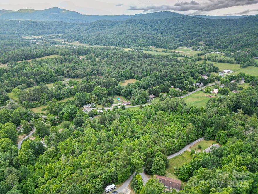 Discover your ideal mountain escape!  This beautiful unrestricted property offers mountain views and a gentle slope, perfect for building your dream home or future development.  Enjoy 50 feet of access from a state maintained road, providing easy entry.  Located just minutes from DuPont State Forest and Pisgah National Forest, and a short drive to downtown Brevard, this land is ideal for nature lovers, outdoor enthusiasts, or anyone seeking privacy and convenience.