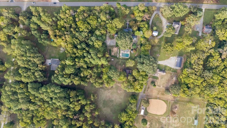 A Victorian-Era Masterpiece with Modern Luxury on 14.87 Acres with 2 parcels

Step into a Victorian-era masterpiece where historic craftsmanship meets refined modern living. This extraordinary 4-bedroom residence showcases ornate woodwork, an original wooden staircase, and vintage hardwood floors, all thoughtfully enhanced with updates that honor the home’s 1880s character. From the welcoming full front porch to the serene rear covered porch, the property radiates a sense of nature, history, and timeless Southern charm.
The home features a primary suite on the main level, fully remodeled with a luxurious bath. The gourmet kitchen is a showpiece, boasting a Bertazzoni Italian gas range, Miele built-in coffee maker, honed marble countertops, and a massive marble island perfect for cooking, gathering, and entertaining. A spacious newly added den—flooded with natural light and offering exterior access—creates an ideal space for relaxation or hosting. The cozy main-level den includes an Osburn wood-burning fireplace insert for added warmth and ambiance.

Outdoors, the property is equally impressive. Equestrian enthusiasts will appreciate the barn, round pen, fencing, and water and electric service, creating a turnkey setup for horses and/or other animals. 

An oversized in-ground gunite saltwater pool offers a private retreat surrounded by curated landscaping, including imported David Austin roses and extensive gardens with fig, Fuyu persimmon, blueberry, and mulberry bushes.

A trail along the right side of the home provides direct connection to the second parcel and Latta Nature Preserve, offering access to 16 miles of scenic trails for hiking, horseback riding, and nature exploration.

This listing includes two parcels, the 9.86 acres that backs up to Latta Plantation and the 5 acre parcel (02303101). Pricing is for both parcels. If a buyer is interested in only the 5 acre parcel, it is listed for 1,850,000 and can be purchased alone, MLS #4308047. 

Proof of funds and/or pre-approval is required to view the property.