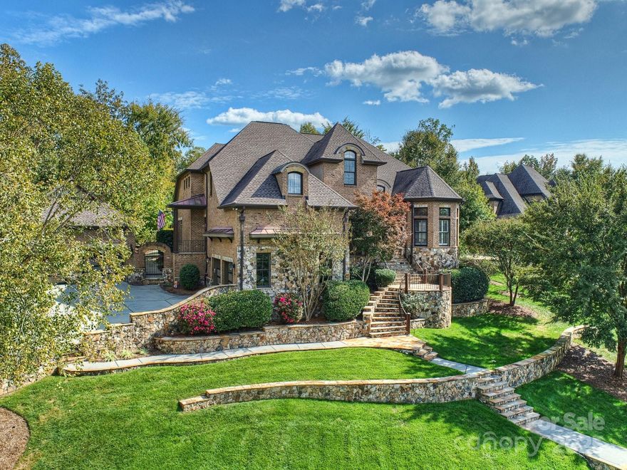 Exceptional home in the gated community of Longbrooke. Fully updated by current owners. Spectacular curb appeal with tiered stonework and terraces. Lush landscaping with fruit & olive trees. Backyard retreat with heated saltwater pool & spa and travertine patio. Iron front door, Australian Cypress wood flooring, 10-13 ft ceilings throughout main level. 2-story foyer flanked by dining & formal living room/study, family room with coffered & beamed ceiling and stone fireplace. Sunroom off kitchen & vaulted breakfast room. Stunning chef's kitchen with island & breakfast bar. Primary suite on main with new marble bath & veranda access. Fully equipped media room with wet bar, loft with secondary staircase, & 3 additional bedrooms. 2-car garage & additional 2-car carriage house garage. Control4 Smart Home system for whole-house/backyard AV. Longbrooke is a meticulously planned community of custom homes. Private, serene location with easy access to Ballantyne.