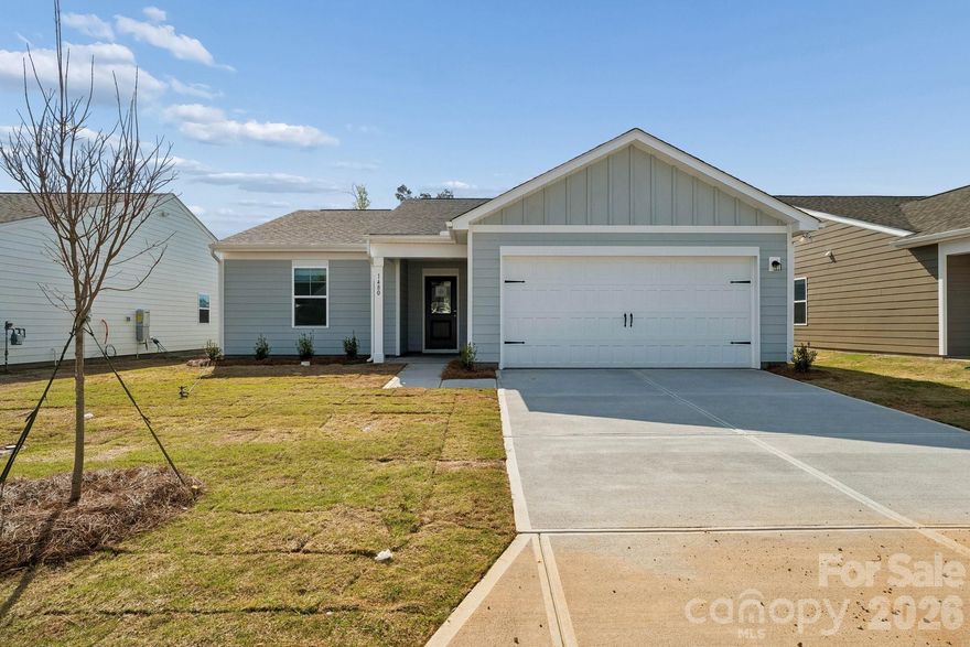 Thoughtfully designed home offering comfort, flexibility, and easy living in a 55+ community. Situated on a desirable interior homesite, this inviting residence features a charming covered front porch—perfect for morning coffee or casual neighbor connections. Offering the ease of main-level living, the home includes a spacious primary suite with a luxurious en-suite bath and walk-in closet, two additional bedrooms, and a full bath. A tucked-away pocket office provides a quiet space for work or hobbies. The kitchen boasts upgraded finishes with a large center island, quartz countertops, and stainless steel appliances, opening to a welcoming living area and access to the back patio overlooking a serene, wooded backdrop for seamless indoor-outdoor living. Combining modern comfort, smart design, and timeless appeal, this home is a standout opportunity—schedule your showing today