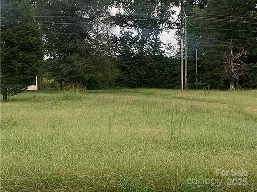 Mins from Lake Norman. You will love this desired area with no HOA fees in the growing Huntersville area.  Land is flat and near the corner of McCoy rd. and Hambright. This land sits in front of the mobile home, however mobile home is behind property line. Land is .23 according to survey. Tax records are incorrect. Restrictions: No more mobile homes. Building setbacks must be 25 feet from front and 8 feet on each side. Front of home must face McCoy street. Modular homes maybe okay if sitting on a foundation and classified as a home by the city or county. City of Charlotte providing the water. Septic Perfect for Tiny-Home Build with an above ground required septic