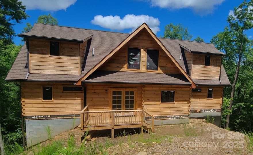 Experience the best of mountain living in this brand-new 2-story cabin with basement, designed to capture breathtaking long-range eastern views. The main level boasts 2 primary suites, each with private baths, plus an additional half bath for guests. The living and dining areas flow seamlessly, creating the perfect setting for entertaining or relaxation. Upstairs, you’ll find 2 more spacious bedrooms, 2 full baths, and a versatile family/entertaining room ideal for game nights or quiet retreats. The unfinished basement offers nearly 1,900 sq. ft. of expansion potential—imagine additional bedrooms, another large living area, or even a private movie room. This cabin also has over 1800 sq. ft. of deck to enjoy the views and the WNC weather! Rustic charm with modern design, this cabin is built for both comfort and flexibility. With its CO already in place, you can move right in and start enjoying the privacy and sweeping views that make this property truly extraordinary. Pics coming 8/20