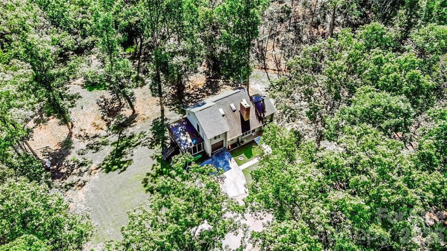 Now offered at $409,900 — 2.51 acres of space and privacy just minutes from downtown Forest City.

If you have been searching for a home that offers room to breathe without giving up convenience, this property delivers the best of both worlds. Situated on 2.51 acres within the established Padgett-Burns community, this thoughtfully designed three-level home provides flexibility, privacy, and the opportunity to enjoy outdoor living in a peaceful setting.

Inside, the main level offers a welcoming living room centered around a striking fireplace, creating a comfortable space to gather and relax. The adjoining dining area opens to the rear deck, while the kitchen provides generous cabinetry and functional workspace for everyday living.

A dedicated office (13'2" x 17'7") on the main level is ideal for remote work, creative space, or an additional sitting room. The nearby laundry/mudroom connects conveniently to the attached garage.

Upstairs, the primary suite offers a private retreat with dual closets and a tiled shower, while two additional bedrooms are arranged along an open-to-below hallway that enhances natural light and architectural character. A shared bathroom with private access from the secondary bedrooms adds everyday practicality.

The outdoor spaces truly define this property. An expansive screened porch (approximately 13' x 23') extends the living area and creates a comfortable place to enjoy the surrounding landscape. Above, a nearly 40-foot rear balcony overlooks the property and offers a quiet place to start the morning or unwind at the end of the day.

The walk-out lower level, which already includes a half bath and exterior access, provides significant potential for future finishing, recreation space, or flexible multi-purpose living.

The homesite itself offers the best of both worlds with approximately one acre cleared and the remaining acreage wooded, providing usable outdoor space while maintaining natural privacy.

Additional features include:

• Semi-circular driveway providing ample parking for guests
• Attached garage with direct interior access
• Established residential setting in Rutherford County
• Community water service approximately $360 annually ($90 quarterly for 2026)

Homes offering acreage, privacy, and flexible living space while remaining close to town amenities are becoming increasingly rare. This property presents a unique opportunity to enjoy both space and convenience in one location.