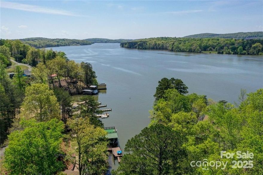 WATERFRONT under $400,000 is hard to find in todays market. Incredible opportunity on Lake Tillery! This 4BR/3BA diamond in the rough offers over 2,300 sq ft and is ready for renovation. Center section was permitted; two new mini-splits with new paint & drywall already in place. Boat lift is disconnected (not rated for seller’s yacht), and boathouse electrical is non-functional. House needs major renovations and is sold as-is. Seller has never lived in or stayed overnight in the home. Located in Holiday Shores with lake access, clubhouse, and boat ramp. Stunning views of the cove and main channel. Montgomery County could not locate any septic permit information. New electrical service permitted and installed. Agent is owner. Run your comps—ARV exceeds $700,000.