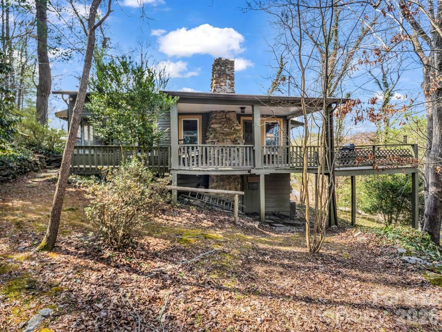 Located in Hendersonville's Hillside Park, this charming 1925 cottage offers an appealing opportunity for investors, second-home buyers, or anyone seeking an attractive short-term or long-term rental property, in a setting that supports an active outdoor lifestyle. Set on 0.26 acres on a wooded hillside near Laurel Park, the Ecusta Trail, Jump Off Rock, and downtown Hendersonville, this two-bedroom, one-bath home offers 956 square feet with convenient access to hiking, cycling, and scenic overlooks. Owned and maintained by the same family for more than half a century, the residence retains its original character with pine floors throughout and an inviting fireplace with brick interior and stone chimney. A wraparound porch and deck extend the living space outdoors, providing a peaceful setting to enjoy wooded views, privacy, and the sounds of nature. Recent improvements completed in 2015 include the roof, heat pump, electrical system, and most windows. With proximity to parks, trails, local breweries, and restaurants, the property offers convenient access to both outdoor recreation and all the amenities of downtown Hendersonville.