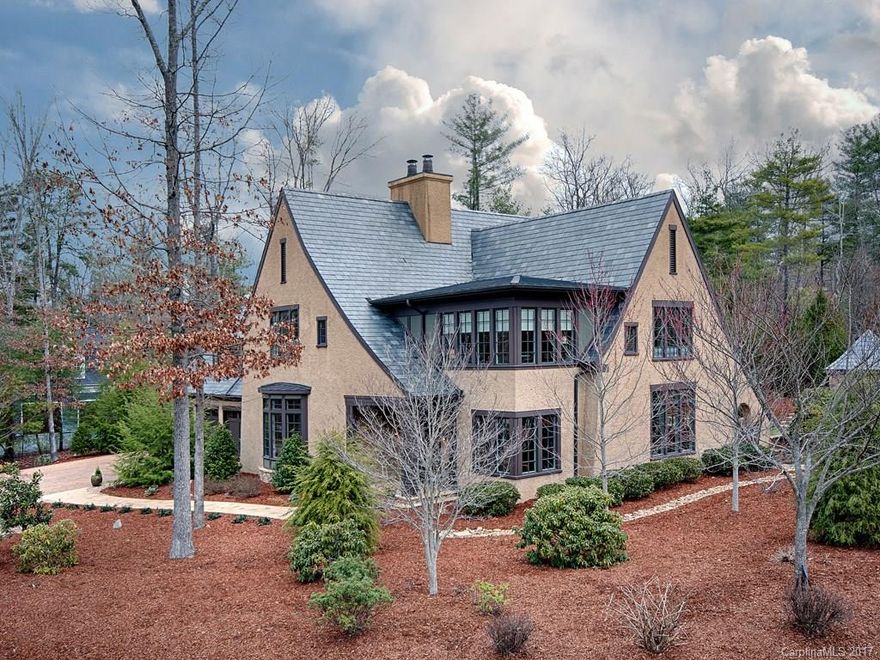 Pebbledash stucco and stone designed by Jim Samsel.  Slate roof, copper gutters, walnut built-ins and woodwork, antique lighting, wine-cellar, stacked closets for future elevator, auto-transfer generator, whole-house water filtration, wood burning and gas fireplaces, beautiful stone patios. Upper level sunroom with closet can be 5th bedroom.  Seller licensed NC RE agent.