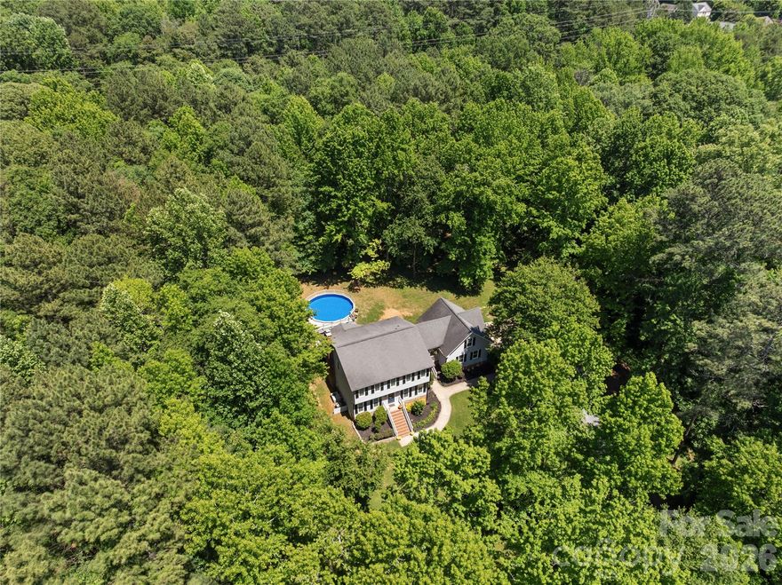 Privacy, space, and warmth come together beautifully in this updated home on a stunning private 3.2-acre lot. From the moment we first saw the home and property, we fell in love and we think you will too. With over 2,900 square feet, this home offers an open-concept living room and kitchen perfect for gathering and entertaining, along with a formal dining room and an additional large flex space ideal for an office, playroom, or second living area. Downstairs also features a laundry room, half bath, and a cozy wood-burning fireplace we loved during the winter months. Upstairs, you’ll find 4 bedrooms, 3 full bathrooms, an office, and incredible storage throughout the home. Some of our favorite memories were made on the screened-in porch, by the pool during summer gatherings, and around the firepit on cool fall evenings. Over the years, we have thoughtfully updated the home with new windows (Sept. 2025), replaced water heater w/ larger unit (2021), new pool liner and filter (2025), rescreened back porch (2025), rebuilt the deck (2020), an updated kitchen, renovated bathrooms, updated light fixtures and switches, popcorn ceiling removal, and fresh neutral paint throughout. The shed also received a new roof in 2025 and fresh paint to match the home. This home has been pre-inspected and lovingly maintained. Please ask your agent for the full list of updates and improvements.