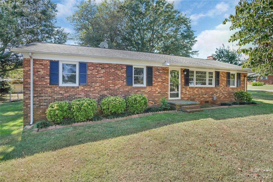 Charming three-bedroom, two-bathroom brick, ranch home in Shelby, NC. This home features a newly installed Heat Pump system and ductwork, along with a spacious living area with refinished hardwood floors & a fireplace! The kitchen features plenty of countertop area with ample cabinet space along with an electric range and refrigerator. Outside, a convenient carport protects your vehicle from the elements, while a large wired building offers endless possibilities - a workshop, studio, or additional storage space to suit your needs. Situated on a corner lot, this home provides ample space for outdoor activities and landscaping. Whether you have a green thumb or simply enjoy the fresh air, the possibilities are endless.