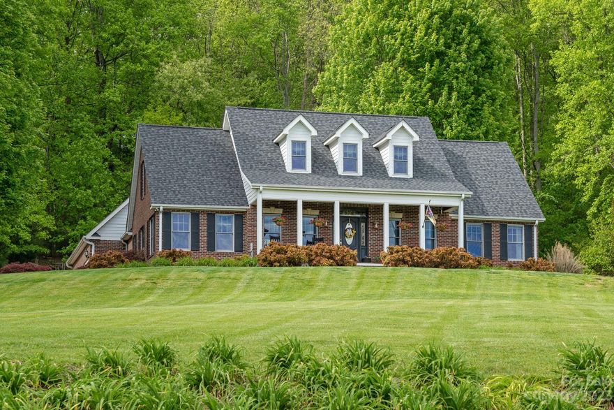 Picturesque setting on nearly 4 acres in popular Mills River area convenient to Hendersonville, South Asheville and Brevard.  Amazing, lush yard with distant mountain views with wooded privacy in back.  Solidly constructed, one owner home with tremendous natural light and many recent updates including Magnolia-inspired kitchen, bathrooms, architectural roof and HVAC.  You'll find a screened porch to enjoy the mountain evenings that opens onto a patio that's ready for grilling and entertaining plus a large, two car garage with 3rd bay for ATV, golf cart or mower.  The stone fireplace will invite you to sit for a spell and enjoy friends or loved ones.  You've got flexibility in the rooms as well.  The upper level has incredible space ready for guests or home office with triple dormers to enjoy the Blue Ridge Mountains.  Established trees and more await in this special setting.  Don't wait another minute, call today to arrange your private viewing of 56 W Chasis Ct today!