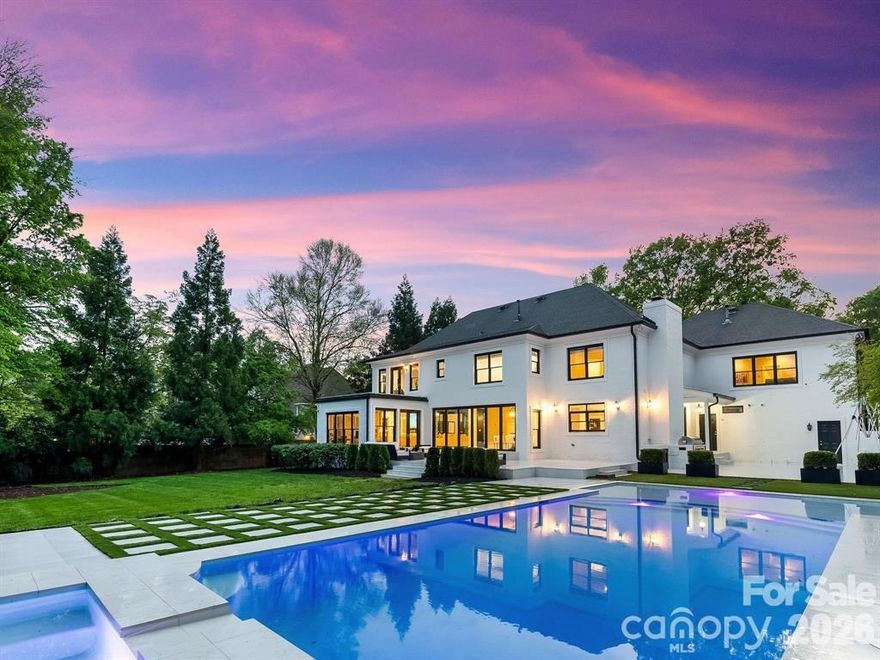 Gated entrances welcome you to this private, estate-sized home in one of Charlotte's most prestigious neighborhoods. The elegant foyer opens to a stunning main-level wine room and flows seamlessly into a spacious family room featuring new lighting and fresh paint. This inviting space connects to a cozy sitting area and an eat-in kitchen nook adjacent to the grand chef's kitchen. The chef's kitchen is a true showpiece, boasting a massive center island, professional-grade appliances—including 4 ovens, 2 dishwashers, 2 refrigerators, and 2 freezers—and beautiful maple hardwood flooring that extends throughout the main level.Upstairs, the expansive owner's suite occupies an entire wing of the home, offering ultimate privacy and luxury. Enjoy two private terraces—one perfect for sunrise views and the other for breathtaking sunsets. The spa-like owner's bath features a jetted tub, an oversized custom shower, abundant closet space, and an array of lavish amenities.The home's expansive living areas lead to a spectacular outdoor oasis, complete with an oversized custom saltwater pool featuring a cascading spa, surrounded by mature, lush landscaping. The entire property is fully gated and fenced, enclosed by a custom brick wall and enhanced with established greenery for maximum seclusion and curb appeal.This exceptional residence combines modern updates, thoughtful design, and resort-style living in a prime, sought-after location.