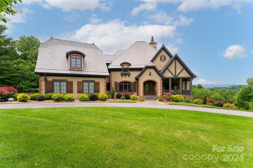 Welcome to 33 Walnut Grove Lane, a stunning Tudor home, blending modern comfort with classic charm in a peaceful and private gated neighborhood. Nestled on 10 private acres, just 8 miles to the center of downtown Asheville, you'll find this beautiful Tudor style home with pebbledash siding, half-timbering and multiple gable roofs. The bright living room with a cozy fireplace, formal dining room, and versatile den provide ample space for relaxation and productivity. The gourmet kitchen boasts granite countertops, stainless steel appliances, custom coffee station, and breakfast nook. The finished basement includes a recreation room, adding extra space for entertainment. Outdoor living is enhanced by multiple outdoor seating areas, a beautifully landscaped backyard, and incredibly expansive views. The attached, pristine three-car garage offers additional storage. Situated on a 10-acres with mature trees and rolling hills, this home provides privacy and a serene atmosphere. No Storm Damage