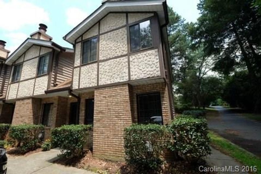 End unit in quiet wooded complex close to Carolina Pavilion and Quail Corners. New carpet, upgraded wood flooring, rustic wood beams in living room, wood burning fireplace, open eat-in kitchen open to covered patio. Fridge and W/D included! Water and sewer in HOA fee. Just a half mile to the LYNX station and walk to CATS bus line. Unbeatable location for the price!
